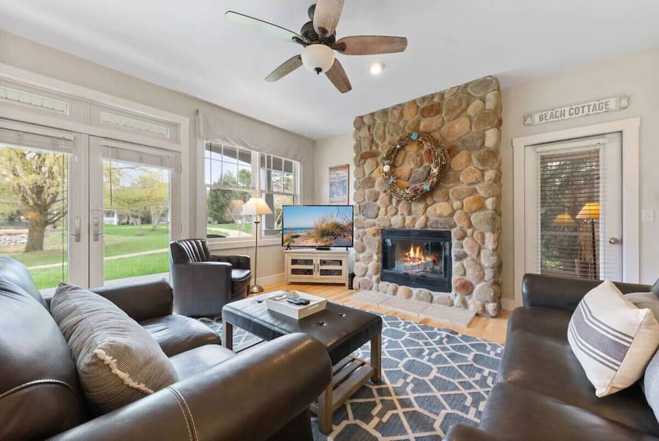 Curl up and unwind by the cozy fireplace in our warm and inviting living room.