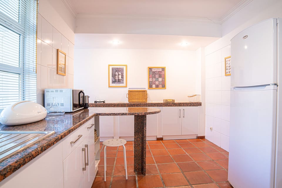 Modern kitchen with granite countertops and breakfast bar — Villa Yara, holiday villa in Grândola
