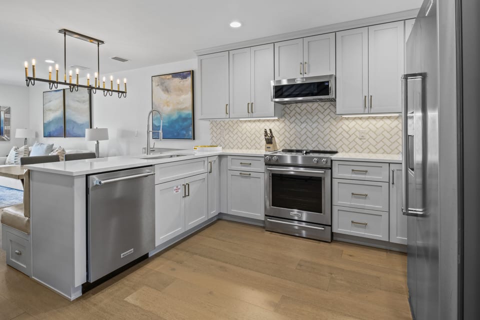 Create culinary masterpieces in this modern kitchen with sleek gray cabinets, granite counters, and premium stainless steel appliances.