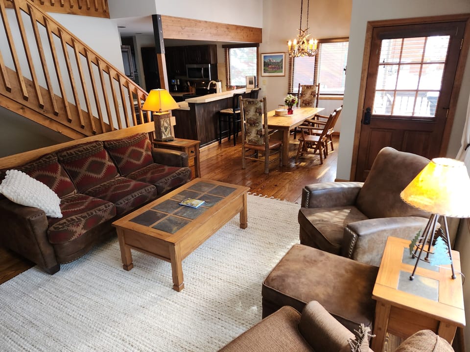 Great room with vaulted ceiling opens to the dining room and kitchen.