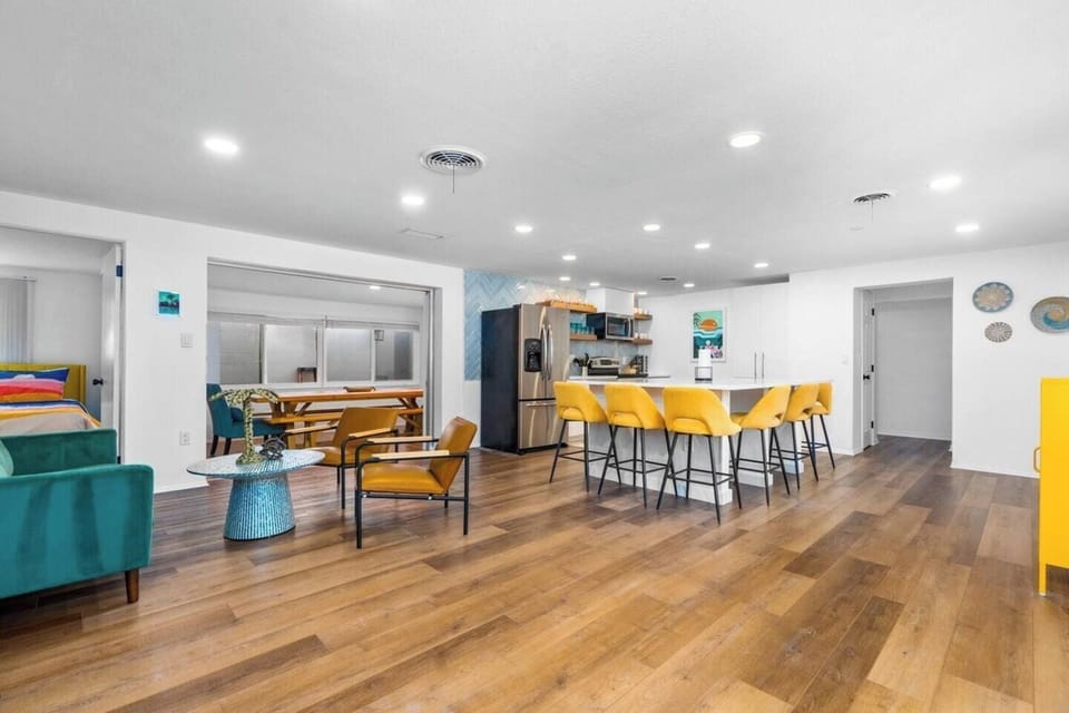 Newly remodeled open kitchen with full slab quartz countertop, seating for 8 and separate sitting area. 
