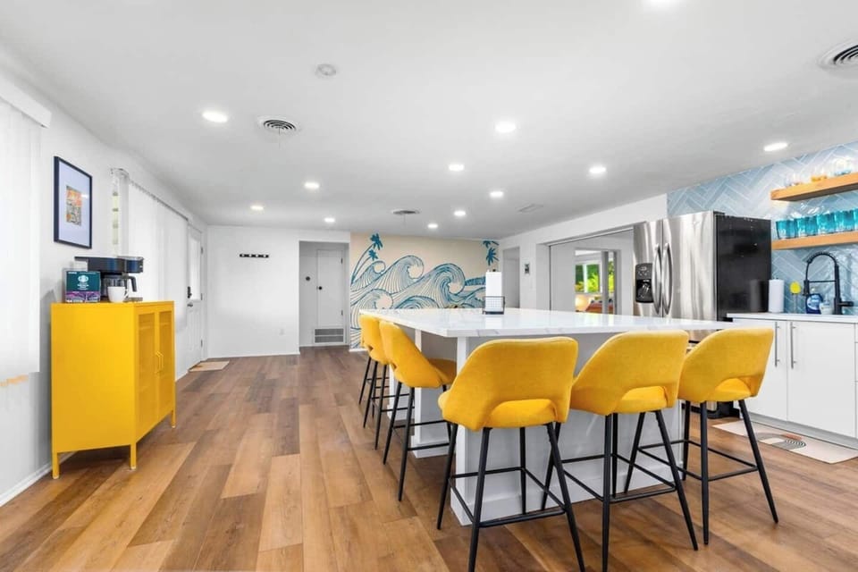 Newly remodeled open kitchen with full slab quartz countertop, seating for 8 and separate sitting area. 