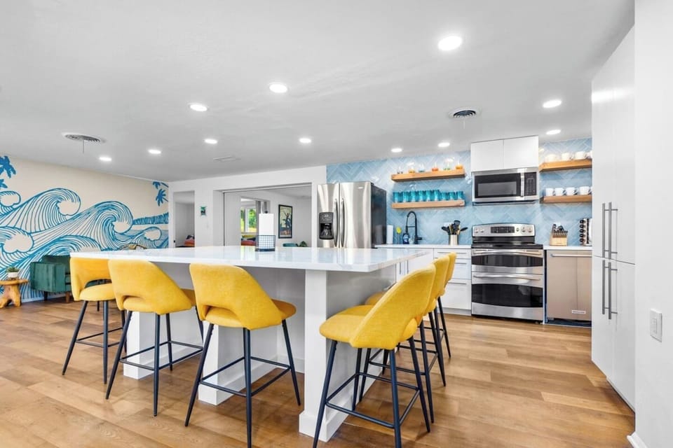 Newly remodeled kitchen with full slab quartz countertop, seating for 8. 
