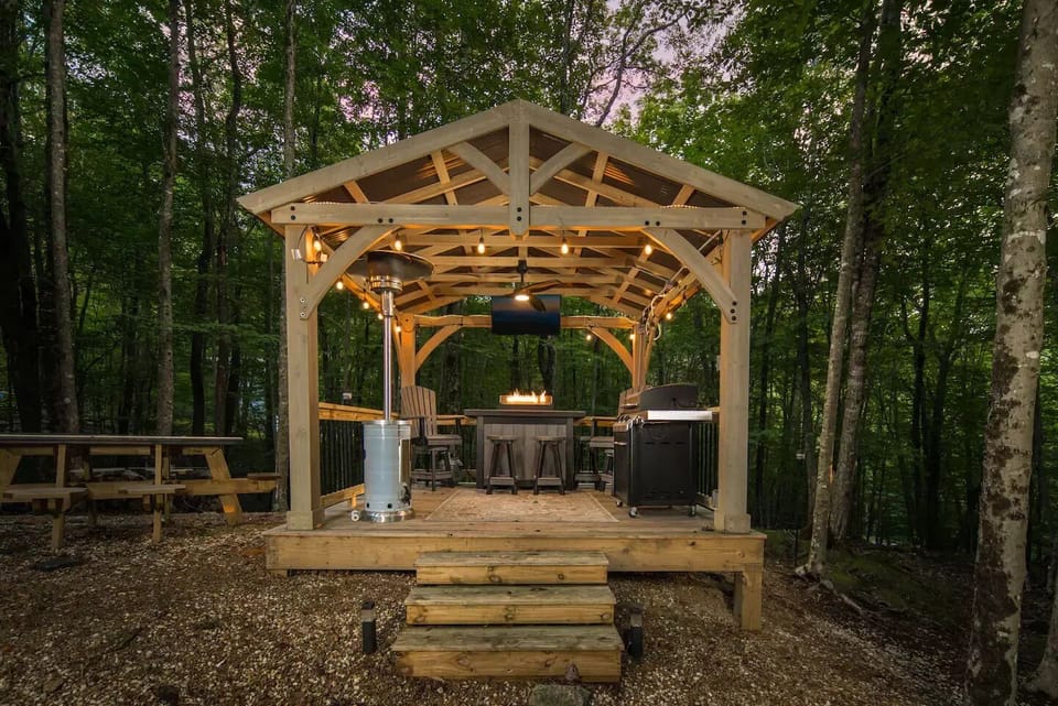 Chill under the stars with a grill, bar, and comfy seating in the gazebo.