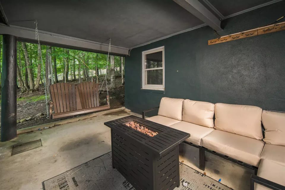 Enjoy outdoor comfort with a fire pit, cushioned seating, and nature views.