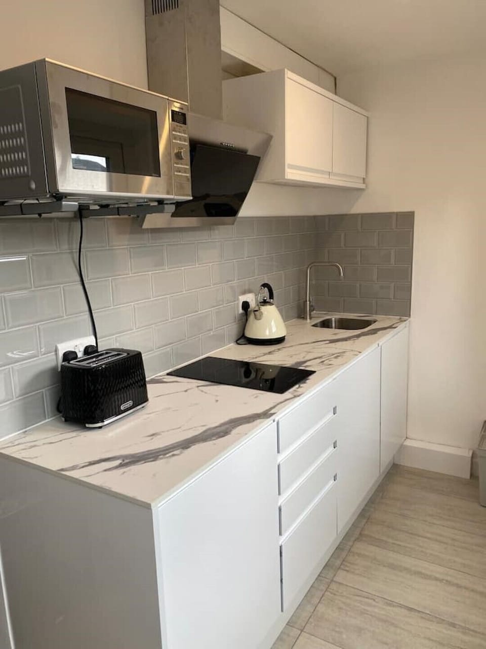 Dual burner stove, microwave oven / grill, kettle, toaster and fridge.