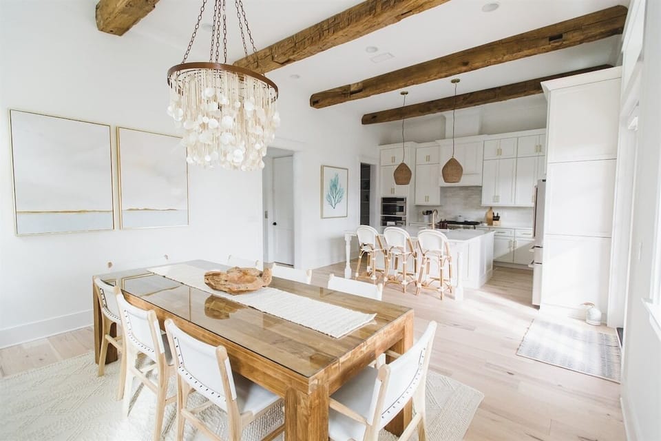 Modern dining and kitchen area with elegant lighting and natural tones.