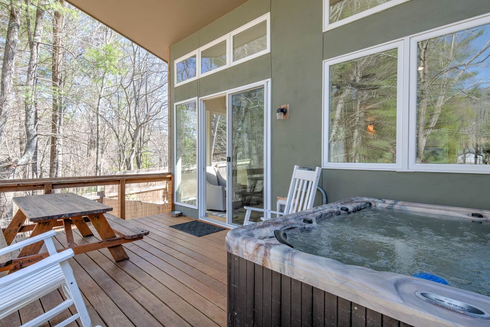 Partially covered rear deck and 5-person hot tub.  Soak in the rain!