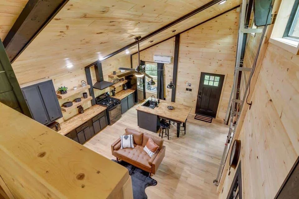 Living room with ladder to loft bed for style and function.