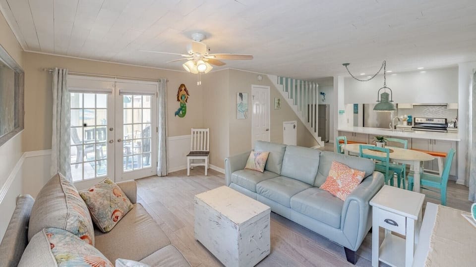 Relax in the living area with 65" Smart TV & doors opening to the screened patio
