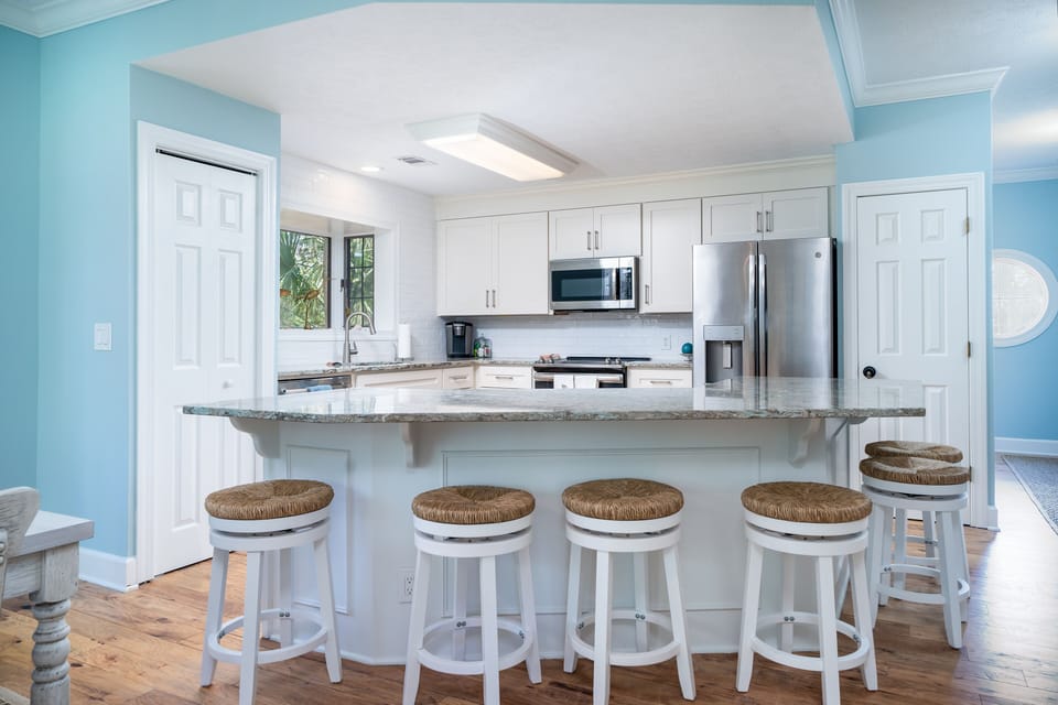 The kitchen is open to both the dining and living areas. The large island seats 6.