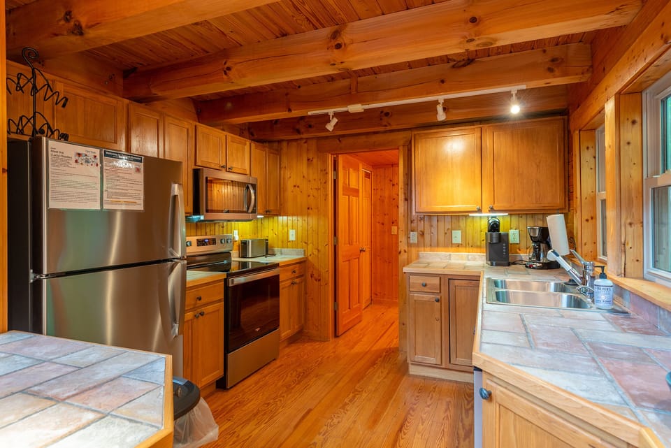 Kitchen with bar seating for 2, dishwasher & 2 types of coffeemakers (standard drip & Keurig).