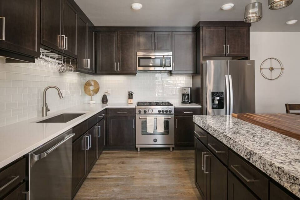 The modern kitchen features granite countertops, stainless steel appliances, and everything you'll need to whip up a meal.