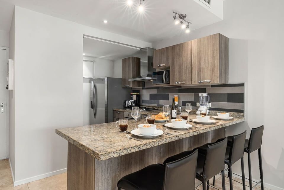 Extra dining space is provided by a kitchen island with four seats.