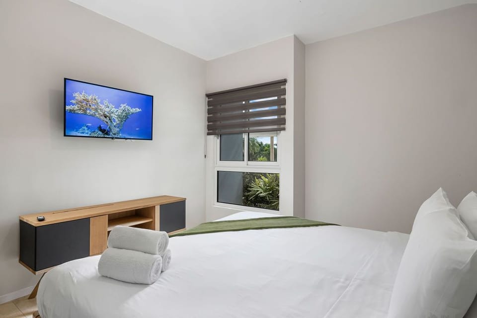Bedroom with king bed, TV and own AC unit.