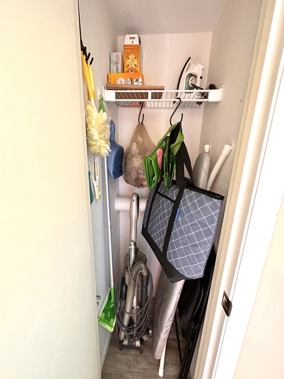 Front entrance closet - iron/ironing board, insulated cooler bag, etc