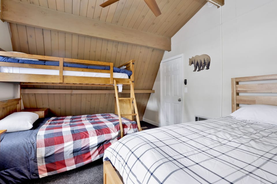 Peaceful cabin bedroom with plush bedding, and beautiful views—ideal for restful nights, cozy mornings, and a relaxing mountain escape.