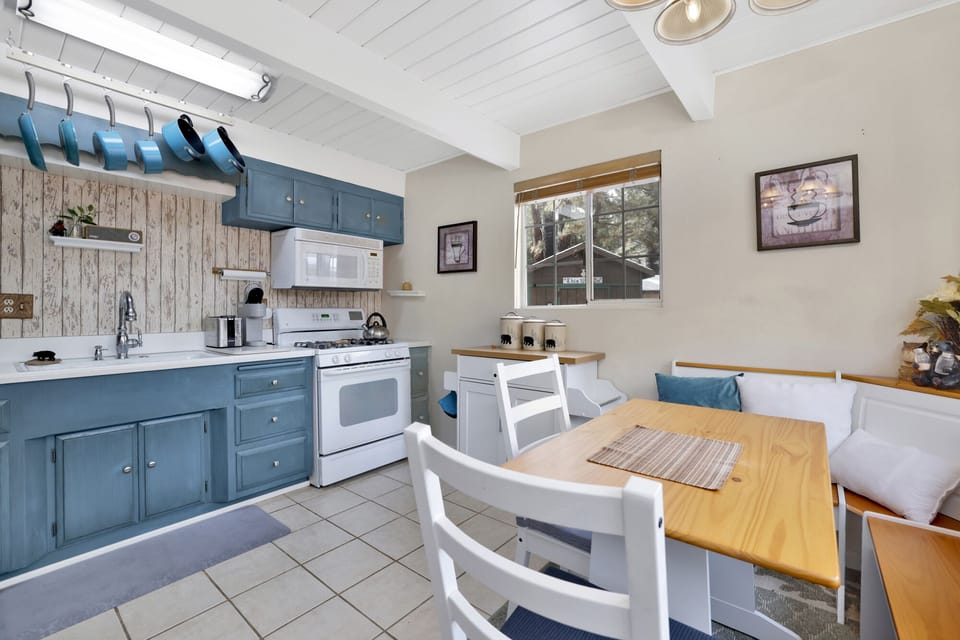 Fully equipped cabin kitchen with ample cabinetry, stove, fridge, microwave, and coffee maker—perfect for cooking meals, morning coffee, and feeling right at home on your stay.