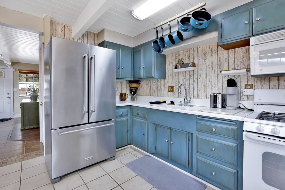 Fully equipped cabin kitchen with ample cabinetry, stove, fridge, microwave, and coffee maker—perfect for cooking meals, morning coffee, and feeling right at home on your stay.