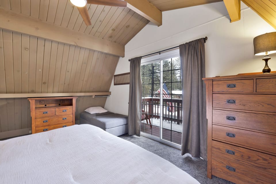 Peaceful cabin bedroom with plush bedding, and beautiful views—ideal for restful nights, cozy mornings, and a relaxing mountain escape.