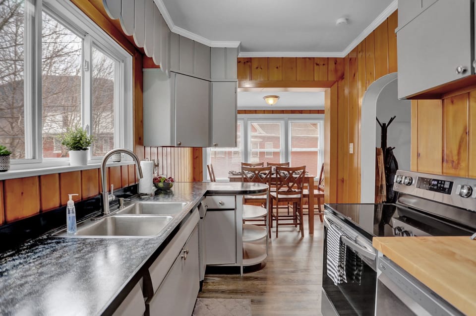 Cozy kitchen with modern appliances, wooden accents, and dining area.