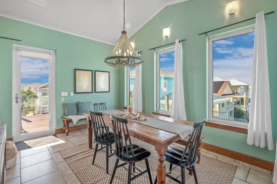 Spacious dining area featuring ample seating options with both chairs or comfortable benches.