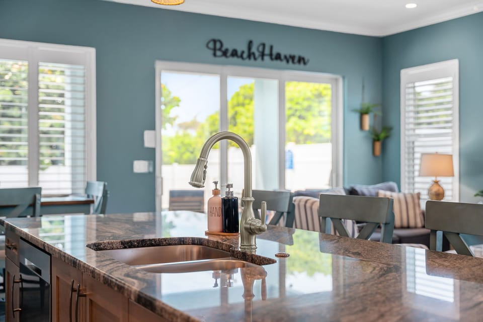 A massive granite island offers ample prep/cooking space as well as room to sit an eat. 