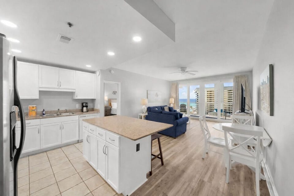 Ocean View Living Area with Sleeper Sofa, TV, Dining Table and Private Balcony Access