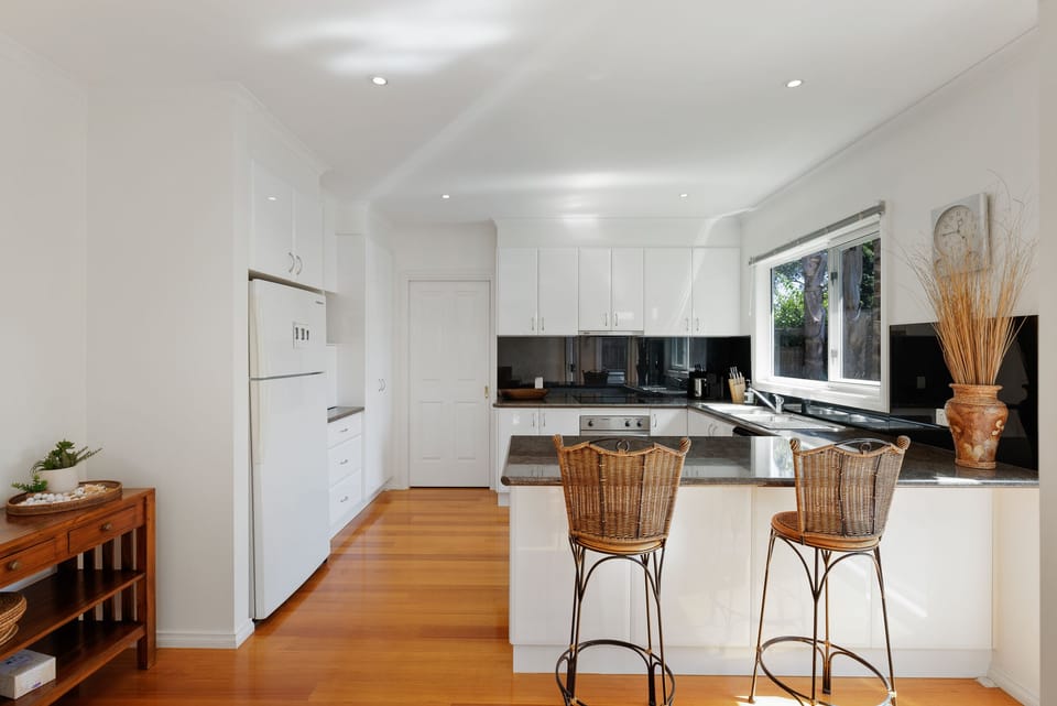 Kitchen area with bar stools to enjoy your morning coffee on