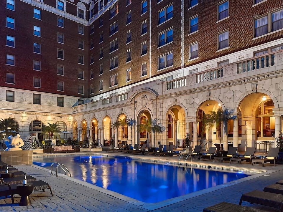 Unwind after dark beside a glowing courtyard pool oasis.
