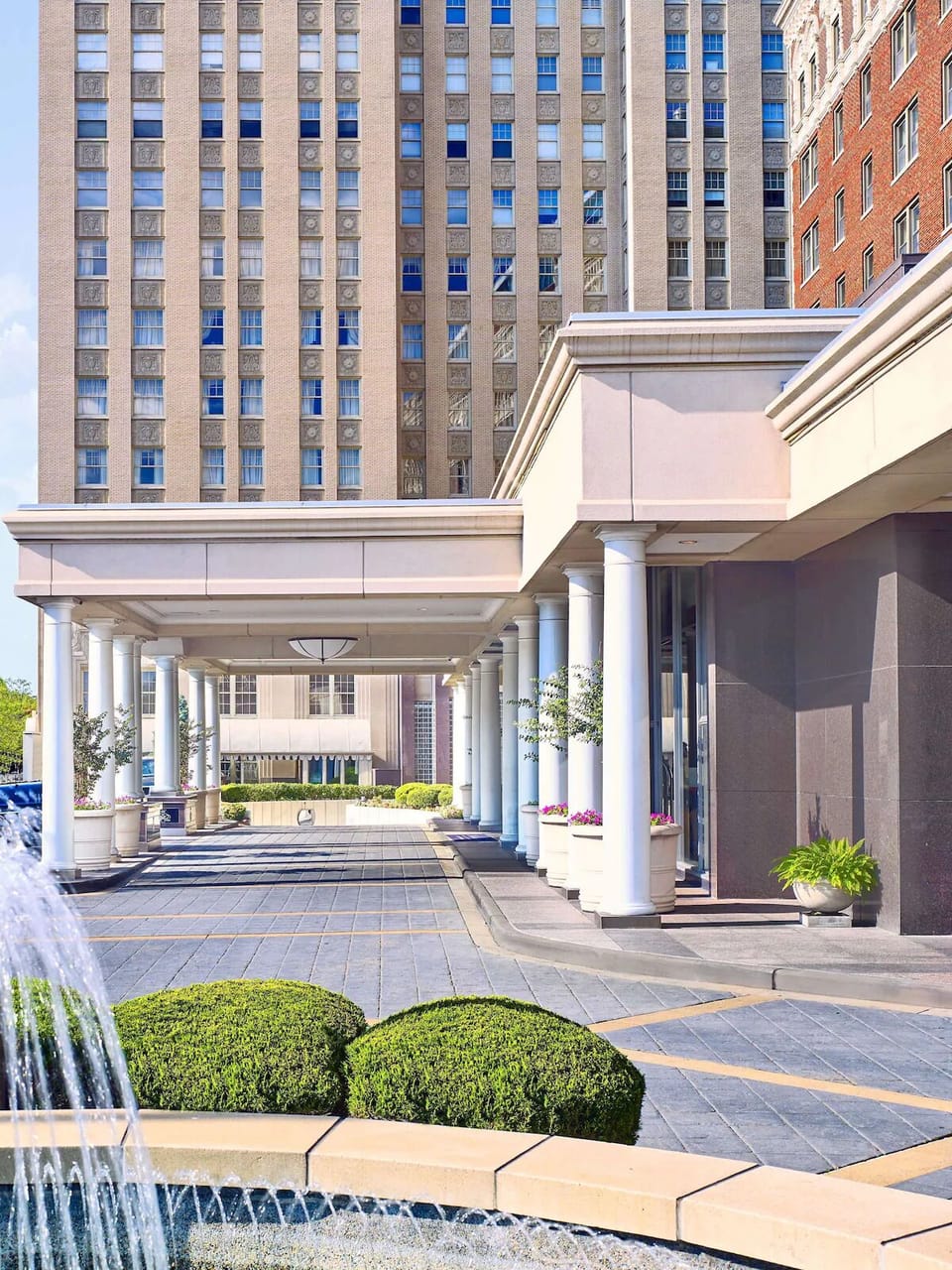 Arrive in style beneath a grand, covered porte-cochère.