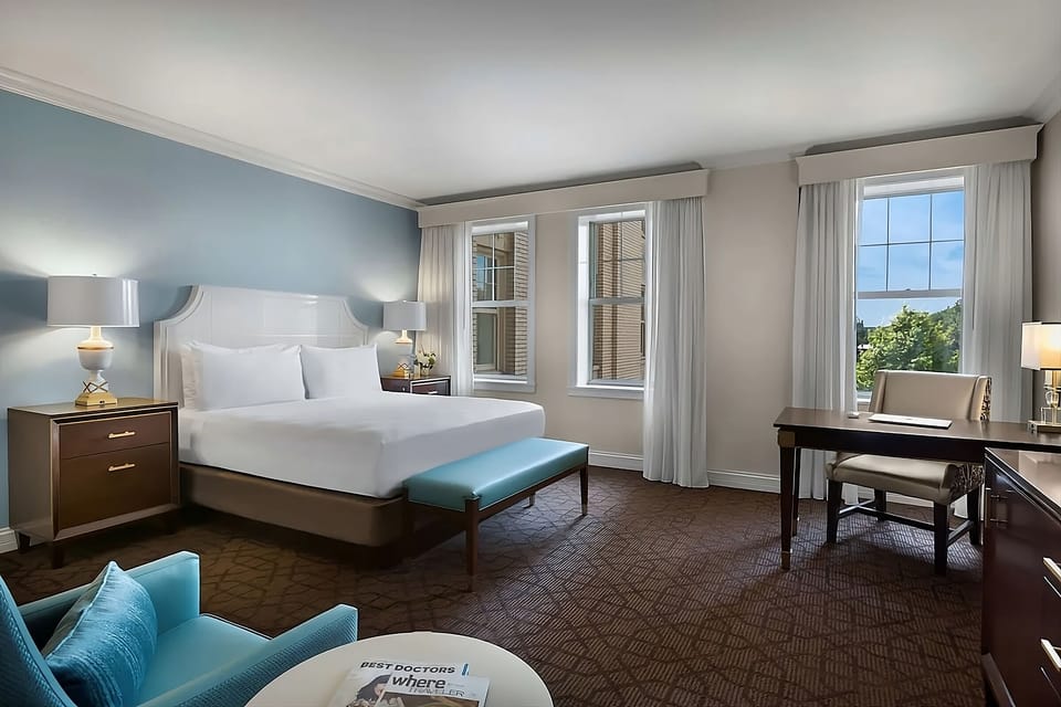 Unwind in a sunlit king room with roomy workspace.