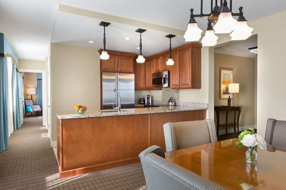 Gather for meals in a full kitchen with granite counters.