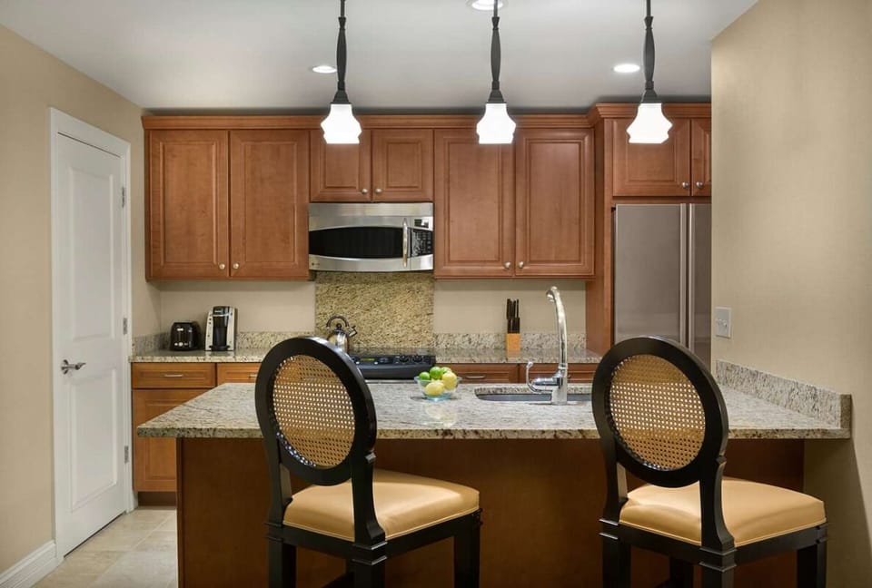 Cook with ease in a granite-topped kitchen with bar seating.