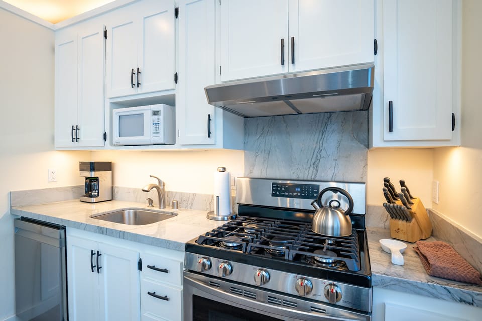 Enjoy a fully stocked kitchen featuring sleek stainless steel appliances, perfect for preparing meals with ease
