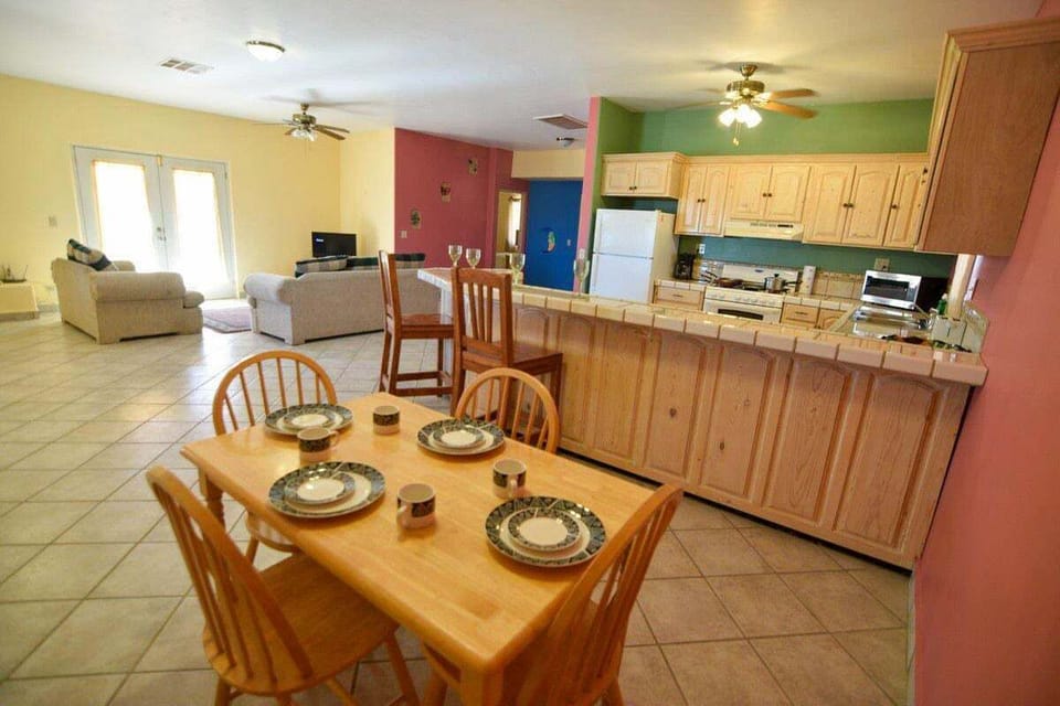 This mountainside rental at El Dorado Ranch features an open-concept layout that offers a clear view from the dining table into the living area.