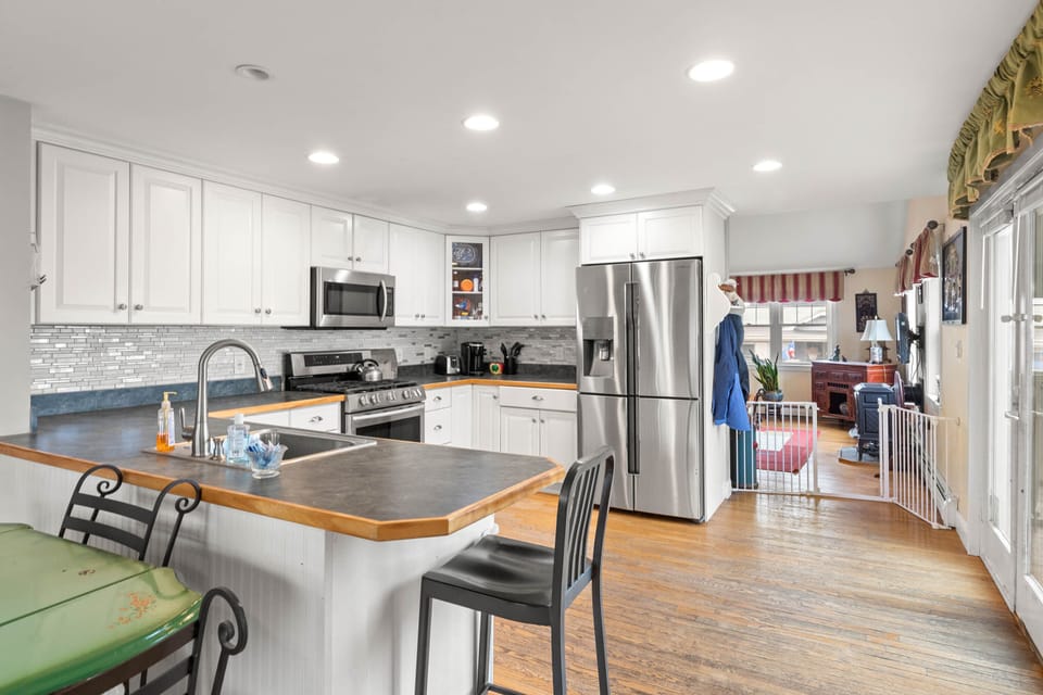 Stainless steel kitchen with dishwasher next to sink.