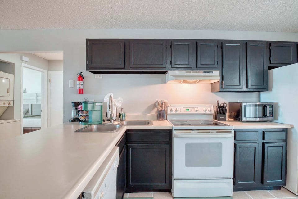 You'll also find a toaster for easy breakfast and a collection of cookware, dishes, silverware, and wine glasses, making this space ideal for entertaining.