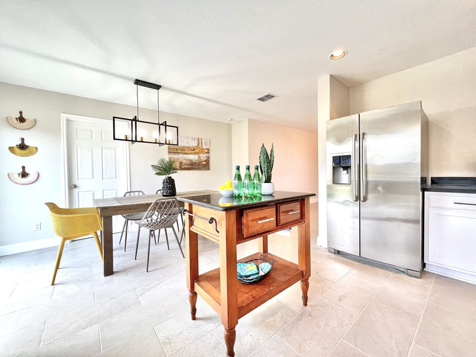 Dine in style with a contemporary table setting and easy access to the kitchen