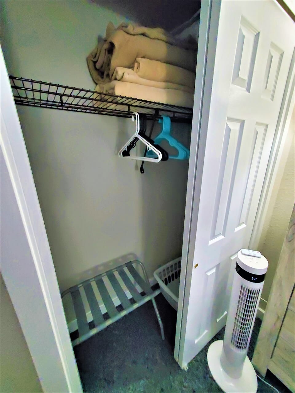 Spare blankets, pillows, hamper, tower fans and luggage rack in each bedroom.