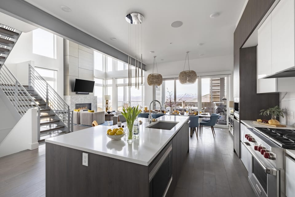 Kitchen features an island with countertop stool seating.