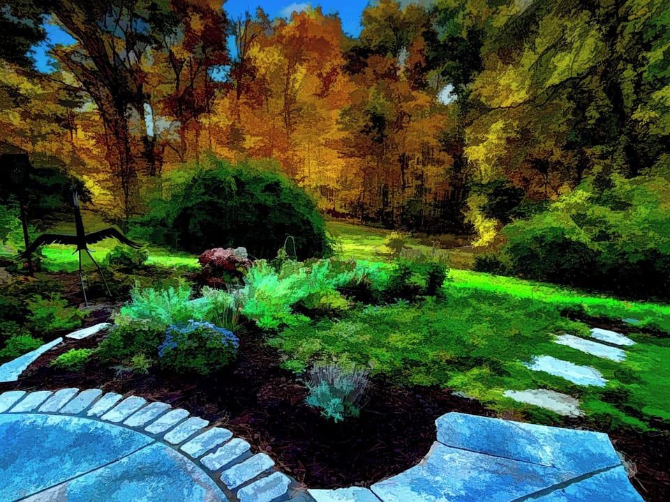 The stone patio allows al-fresco dining in a flower-filled garden.