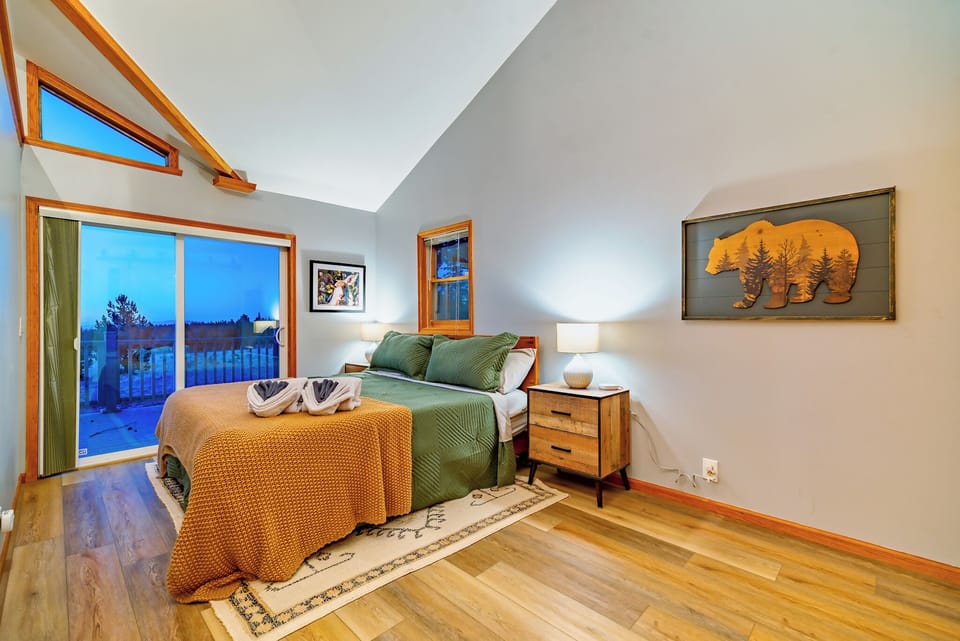 Single bedroom open to the living area with king size bed. Glass door opens to the back deck with views of the sunrise.