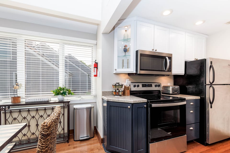 Well-equipped kitchen with stainless steel appliances and a bright dining area.