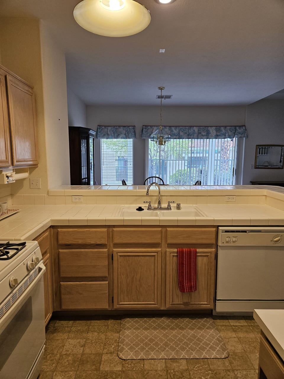 Kitchen with dishwasher looking out to dining room and back patio