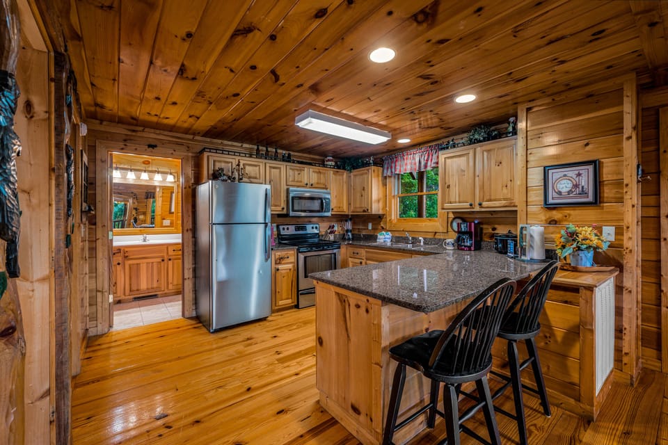 Fully equipped kitchen with additional bar seating.