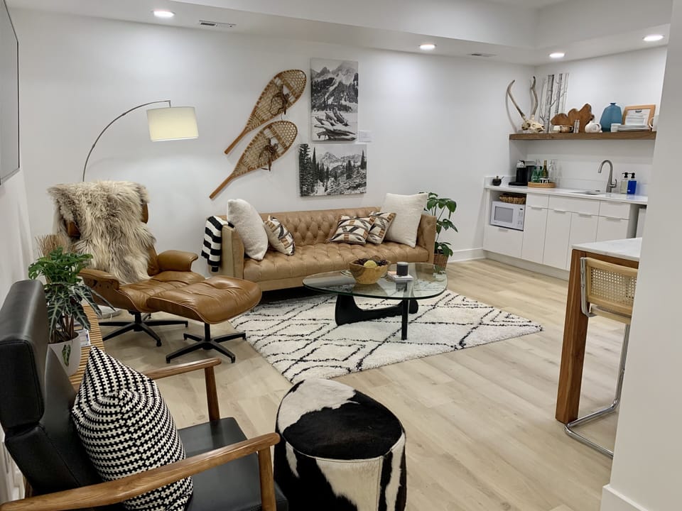 Another vantage point of living room with flat screen Smart TV and small kitchen