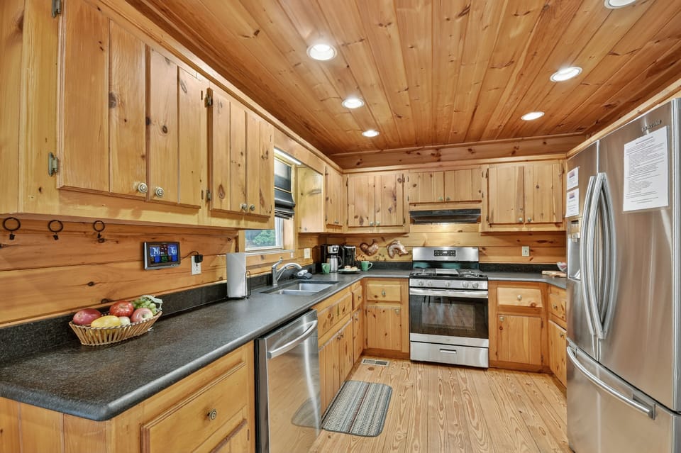 The heart of this family-sized Blue Ridge cabin rental is its well-appointed kitchen with stainless steel appliances
