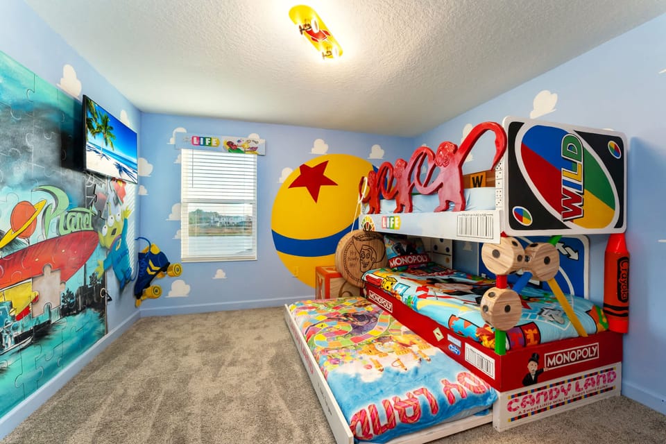 Step into a whimsical board game wonderland with themed bunk beds and vibrant murals, perfect for a family adventure.