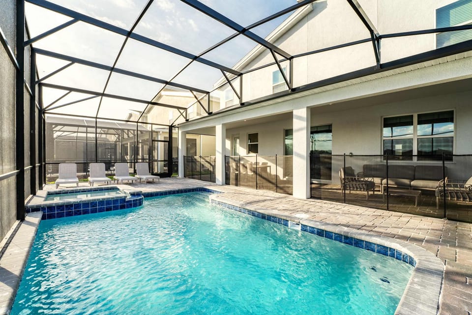 Dive into luxury with your private screened pool and ample seating, perfect for relaxation and entertaining.